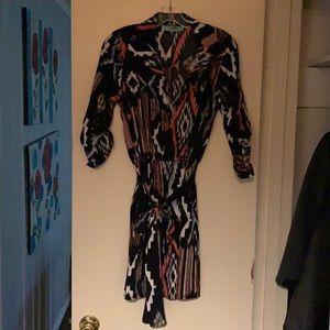 Dress 3/4 length sleeves. Cinched waist with a belted tie.